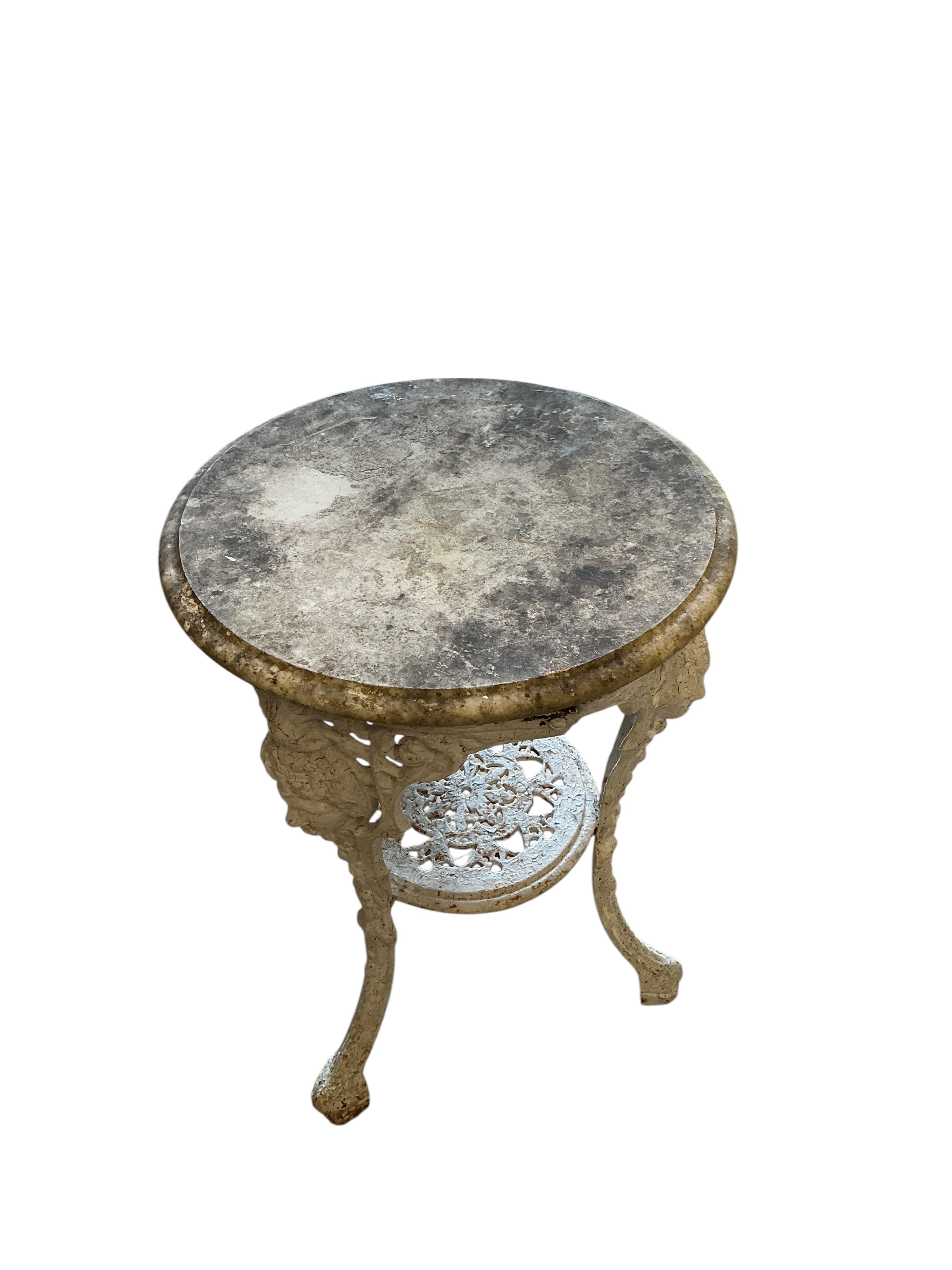 A Victorian cast iron circular marble top table, diameter 50cm, height 70cm